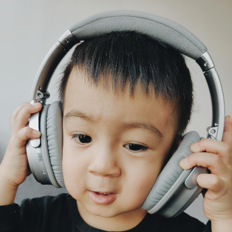 "boy wearing grey cordless headphone" by Eric ZHU on Unsplash